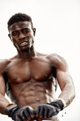 Fototapeta na wymiar strong muscular black man with naked torso, bodybuilder concept. african sportsman having strong abdominal abs. Close-up portrait, copy space. people, workout, sport