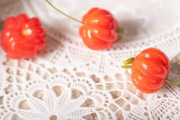 Pitanga, Pitangas placed on a white plastic tablecloth on the table, selective focus.