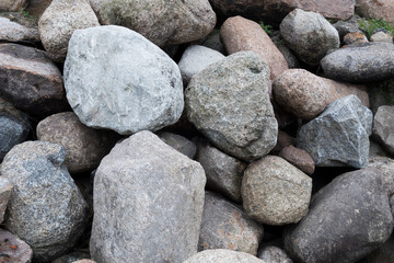 Rockfall on the road in the mountains. Stones of different sizes. Landslides.