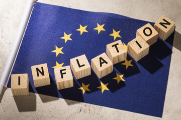 EU flag and wooden cubes with text, concept on the theme of inflation in the European Union - obrazy, fototapety, plakaty