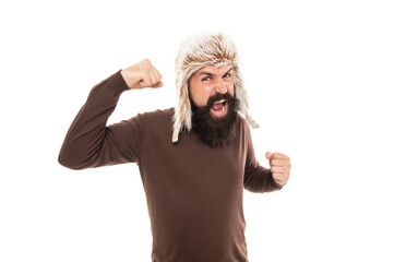 mens anger. angry shouting man portrait. mature man with beard in earflap hat.