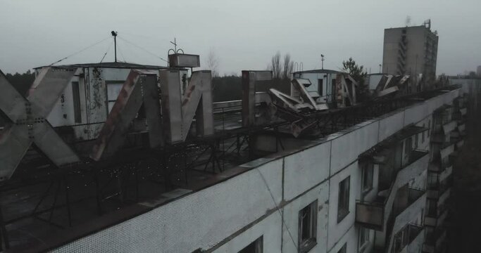 The inscription on the roof of an abandoned building "Atom lives on emptiness" in pripyat near Chernobyl