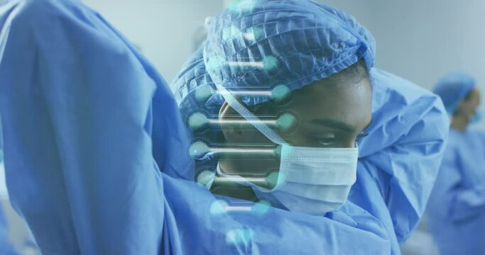Animation of dna strand over diverse doctors with face masks during surgery