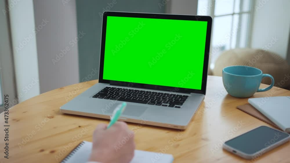 Fototapete man looking at green screen on work laptop. office person using laptop computer with green screen. g