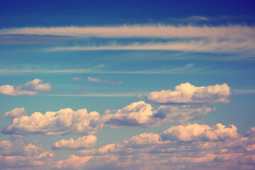 White clouds on a soft sunset sky, evening cloudscape