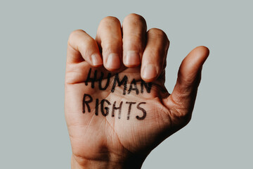 the text human rights in the hand of a man