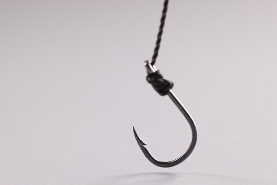 Closeup Of Fishing Hook On String On Gray Background