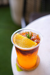 selective focus Long black coffee mixed with orange juice on white table. iced drink menu of summer drink for relaxing day.
