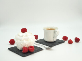 French dessert. Merengue with raspberries and black coffee. Close-up