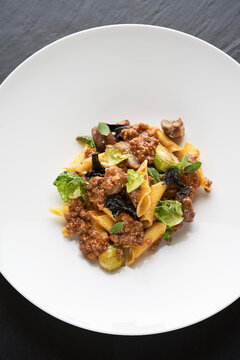 A pasta dish with a wild boar sauce, black chanterelle and Brussels sprouts