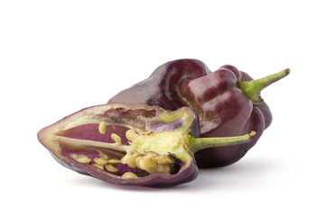 purple habanero chili pepper, whole fruit and a slice isolated on white background, closeup macro