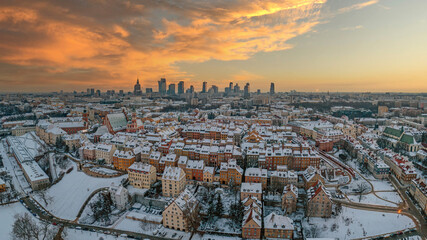Fototapeta Warszawska starówka przykryta śniegiem, centrum miasta w oddali, zimowa panorama miasta z lotu ptaka obraz