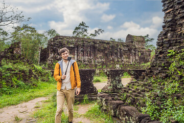 Man tourist in Temple ruin of the My Son complex, Vietnam. Vietnam opens to tourists again after...