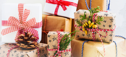 Colorful wrapped gift boxes with presents on white textured background. Selective focus.Place for text.