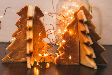 Cookies in the shape of Christmas trees and Christmas lights, close-up. Homemade cakes for the holidays. Delicious. For the sweet tooth. Background with food.  Yummy 