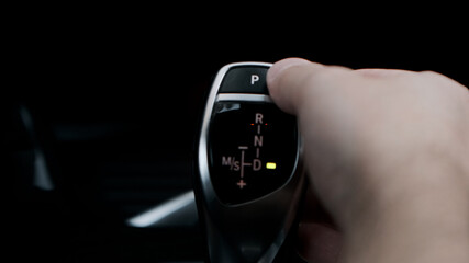 Man shifts gears with joystick with one hand