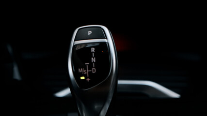 Man shifts gears with joystick with one hand