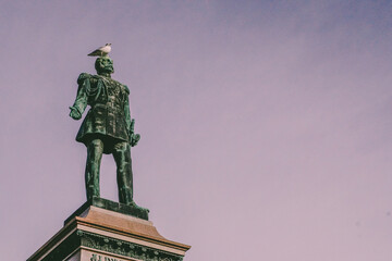 Bird sitting on a statue of Alexander II
