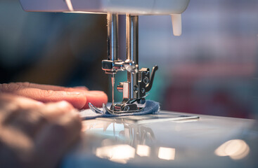 close-up of a seamstress on her sewing machine