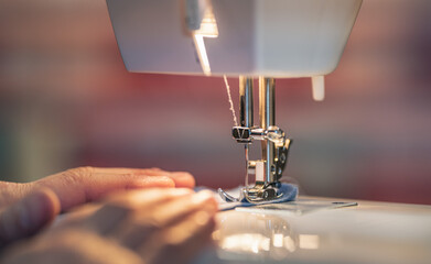 close-up of a seamstress on her sewing machine