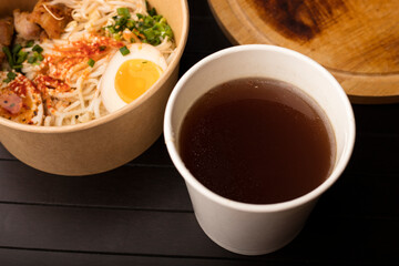 A glass of delicious beef broth, Japanese dish with wheat noodles. A platter of Chinese, Korean and Japanese cuisine