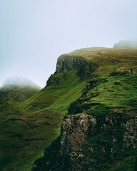 man hiking in distance with clouds