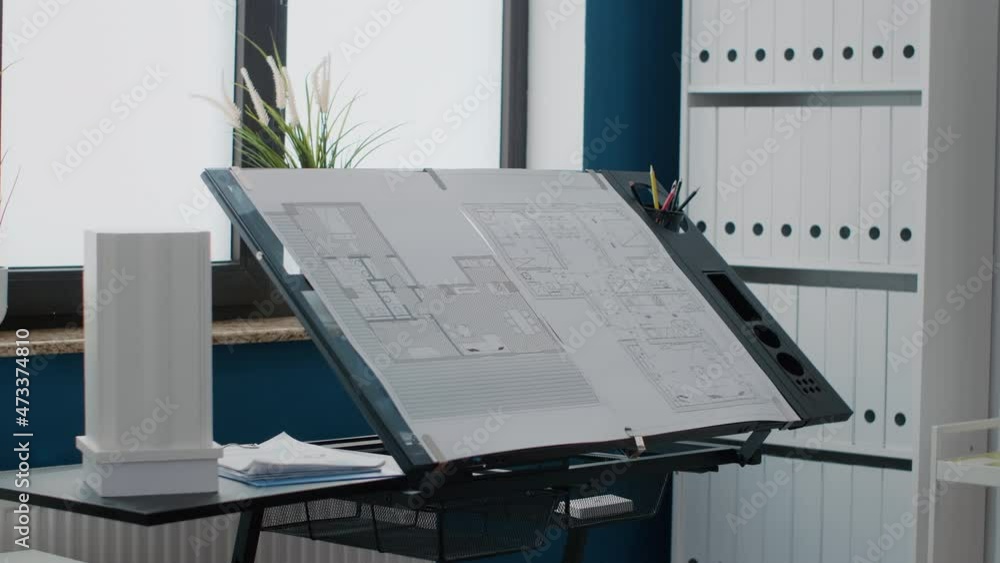 Poster close up of blueprints plans to design building layout on table in workplace. empty office with indu