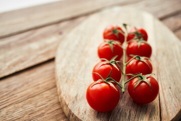 cherry tomatoes on a branch on a wooden board kitchen ingredient fresh food