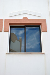 Wall with Close Up of Modern Window with Reflections in Glass