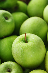 Juicy Green apple close-up with dew drops.