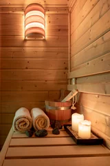 Tuinposter Interior of a small Finnish wooden sauna with sauna accessories. © Alessandra Finding