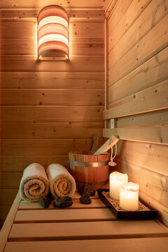 Interior of a small Finnish wooden sauna with sauna accessories.