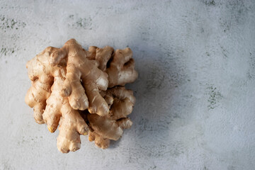 Ginger root on a gray cement background.
