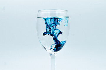 A glass of water with ink