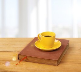 Home office workspace with coffee cup, and book