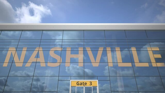 Airliner reflecting in the windows of airport terminal with NASHVILLE text