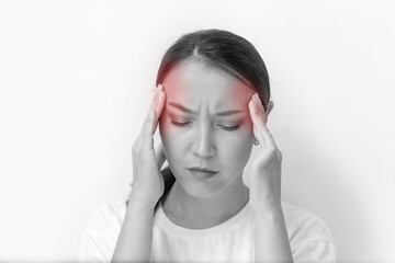 asian girl with headache holding her head. monochrome image with red spots of pain. moody young woman with migraine on white background