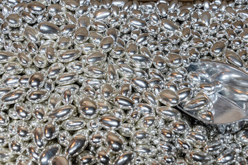 Sale by weight of chocolate candies of silver colour