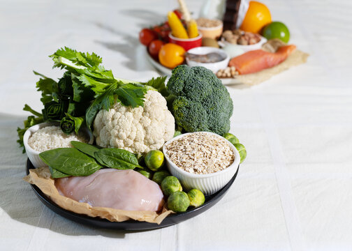 Elimination diet concept. A woman avoids food allergens - fish, seafood, dairy, peanuts, tree nuts, eggs, chocolate, wheat, soy, citrus fruits.