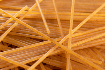Raw whole wheat spaghetti bunch. Macro. Brown organic pasta