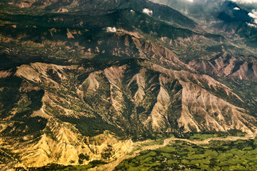 Aerial view of himalayan mountains of Ladakh, green landscape with mountain peaks and Indus river flowing beneath. Ladakh, Jammu and Kashmir, India