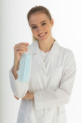 Covid19, coronavirus, healthcare and doctors concept. Portrait of optimistic russian female doctor assure everything be okay, wear medical mask to prevent catching virus, white coat.