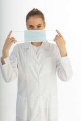 Covid19, coronavirus, healthcare and doctors concept. Portrait of optimistic russian female doctor assure everything be okay, wear medical mask to prevent catching virus, white coat.