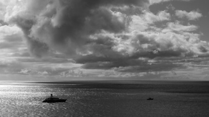 Private yacht and cloud formations