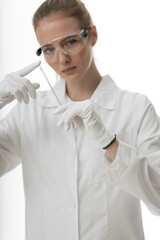 The girl laboratory assistant shows an indicator tube with the result of the analysis. Laboratory assistant in a medical laboratory or a petroleum product quality laboratory
