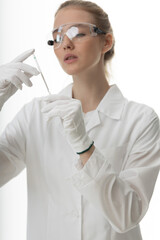 The girl laboratory assistant shows an indicator tube with the result of the analysis. Laboratory assistant in a medical laboratory or a petroleum product quality laboratory