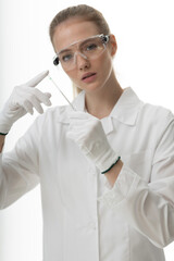 The girl laboratory assistant shows an indicator tube with the result of the analysis. Laboratory assistant in a medical laboratory or a petroleum product quality laboratory