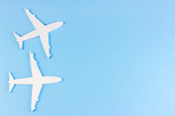 Naklejka na ściany i meble Top view flat lay of white plane models on light sky blue background with copy space.