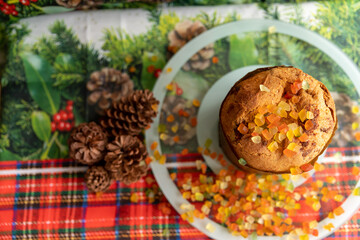 Panettone decorated with candied fruit on the table for Christmas Day. Top view photo