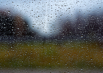 Small drops formed on the window pane. Water droplets are photographed in close-up.